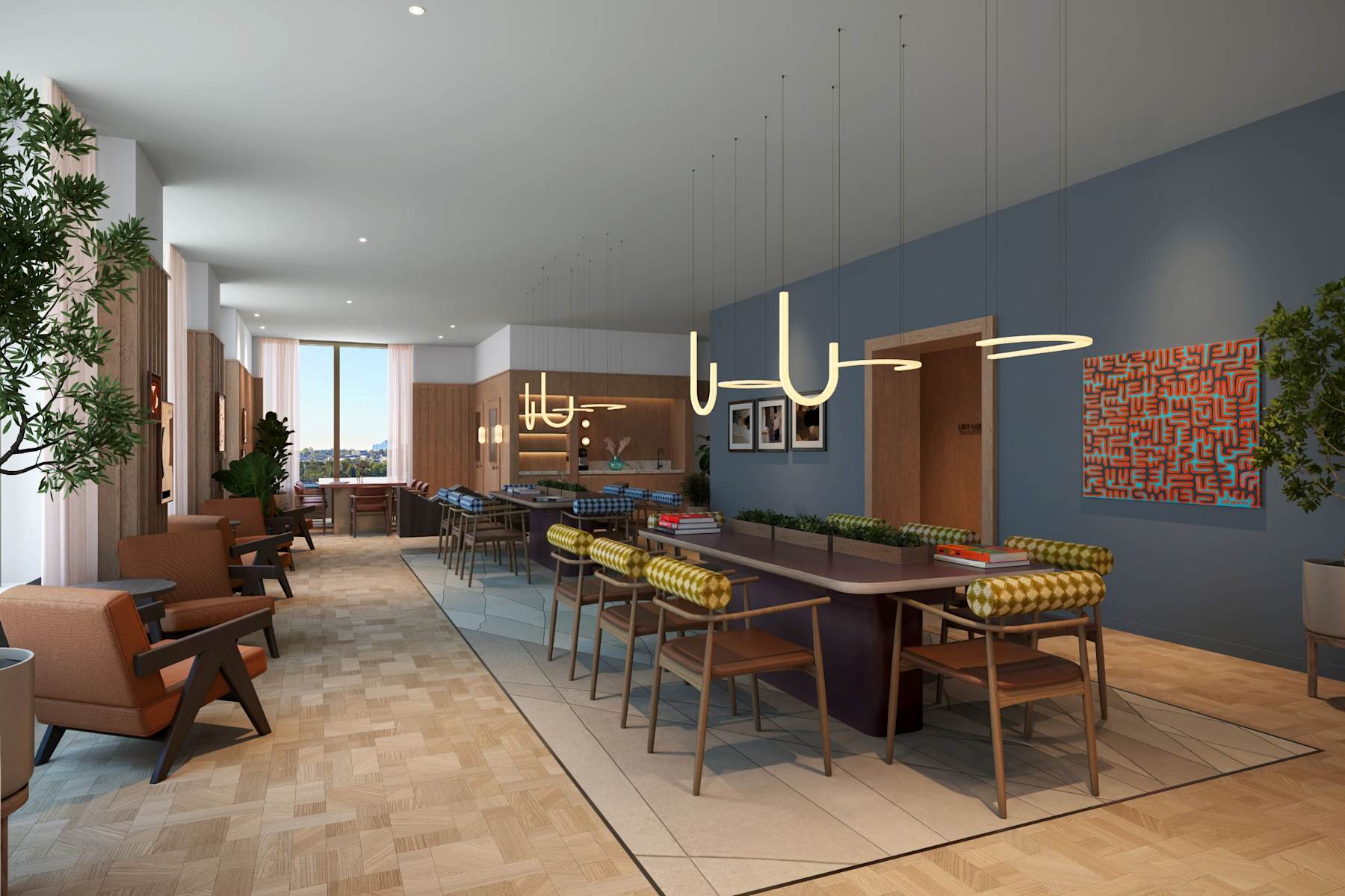A long table and chairs in a light-filled co-working lounge