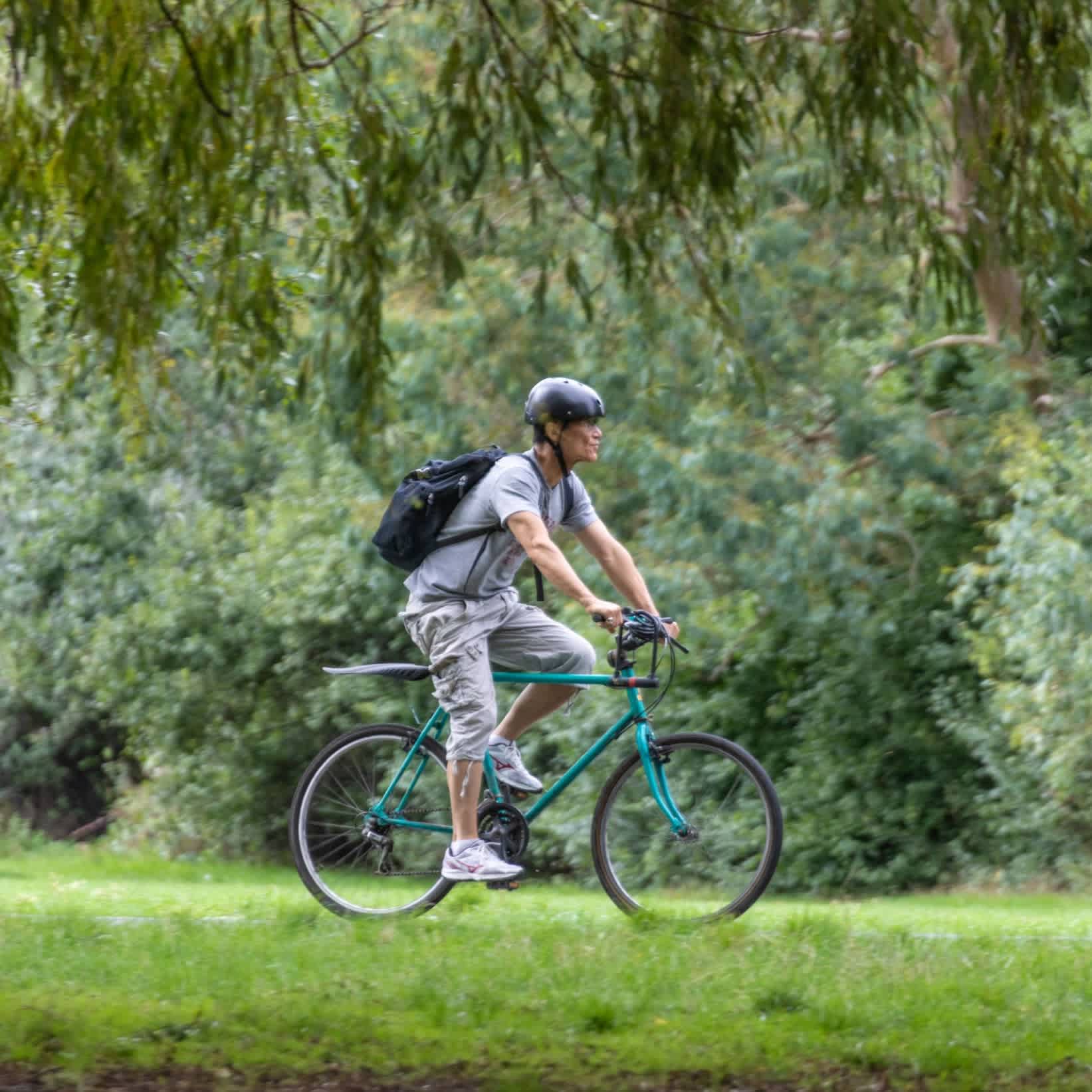 A cyclist riding through Clissold Park in North London